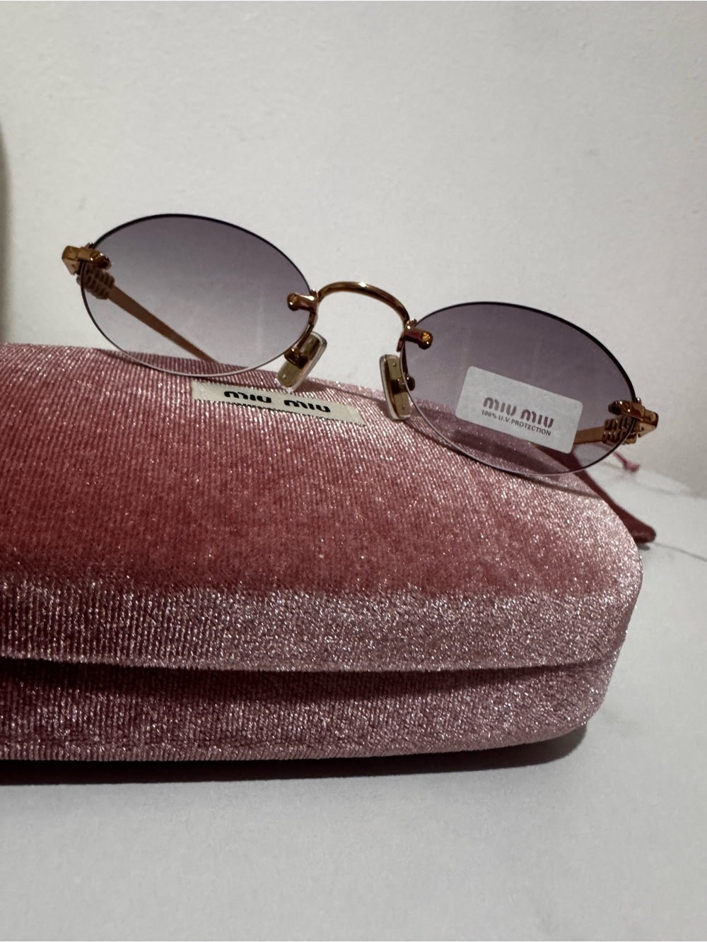 Miu Miu Rimless Oval Sunglasses with Purple Lenses and Gold Bridge